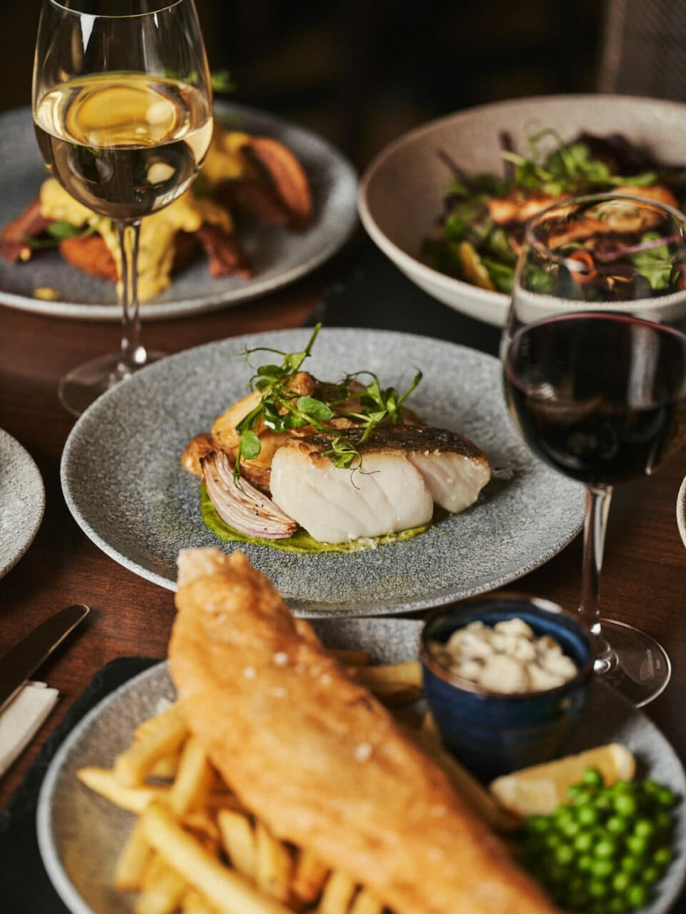 Several plates of food and wine prepared in Milton Brasserie